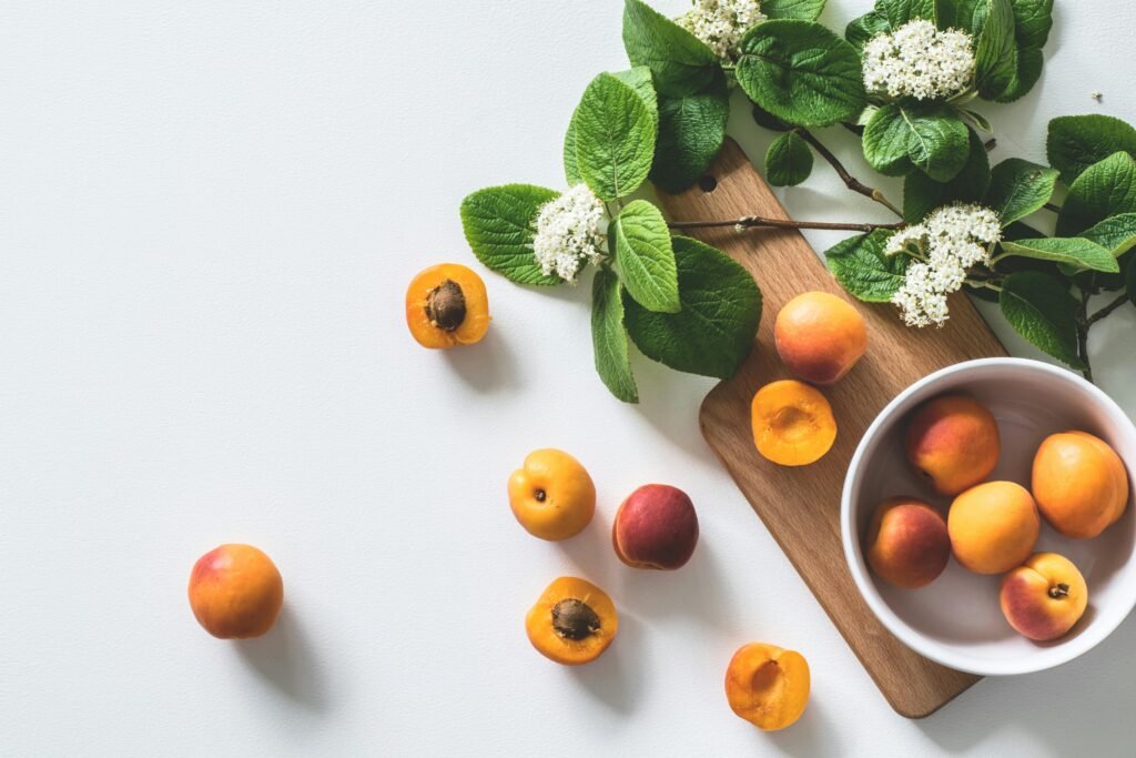 pexels photo 1028599 1028599 A bright still life of fresh apricots and blossoms on a cutting board, perfect for healthy eating.